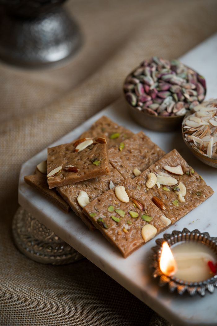 journey Delicious Indian sweets with assorted nuts, perfect for festive occasions.